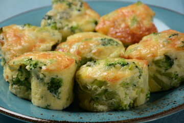 Healthy snack Broccoli muffins with cheddar cheese and thyme close-up on the table.