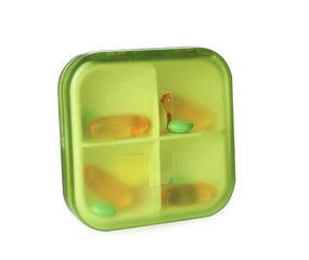 Plastic box with different pills isolated on white