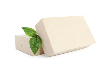 Blocks of delicious raw tofu with basil on white background