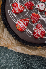 chocolate tart with strawberries close up detail