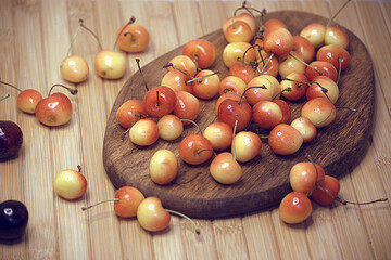 Yellow cherries on a wooden base