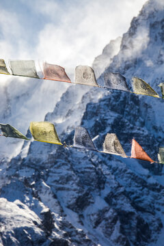 Colorful prayer flags in snowy mountains