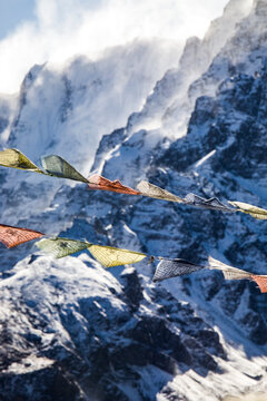 Colorful prayer flags in snowy mountains