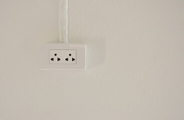 electrical power socket plug outlet  on white concrete wall background with copy space.
