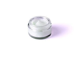 Glass jar with body cream on white background. Cosmetic product for skin care. Transparent jar with face cream isolated.