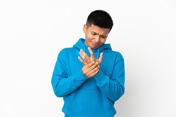 Young Ecuadorian man isolated on white background suffering from pain in hands