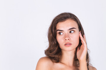 Fototapeta premium Young beautiful natural soft clean skin woman with freckles light makeup on white background with bare shoulders