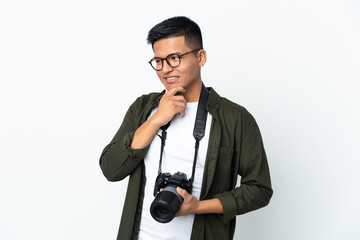 Young Ecuadorian photographer isolated on white background looking to the side and smiling