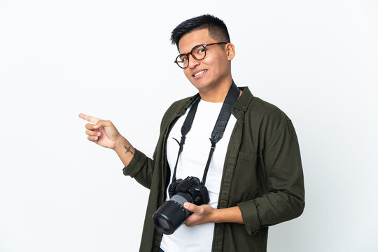 Young Ecuadorian photographer isolated on white background pointing finger to the side