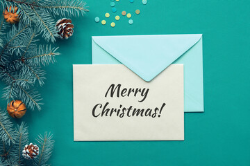 Greeting Merry Christmas on postcard with envelope. Traditional Xmas background with text and paper...