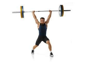 Full length portrait of a man in sportswear exercising with a weight isolated on white background