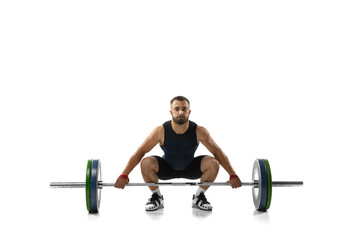 Full length portrait of a man in sportswear exercising with a weight isolated on white background - obrazy, fototapety, plakaty