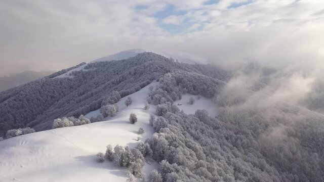 Amazing aerial flight over winter mountains range