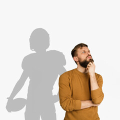 Young man dreaming about future in big sport. Becoming a legend of american football. Shadow of...