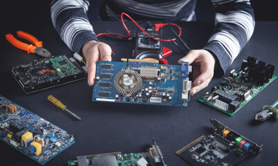 Repairman trying to repair motherboard.