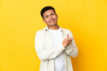 Young Ecuadorian man isolated on yellow background applauding
