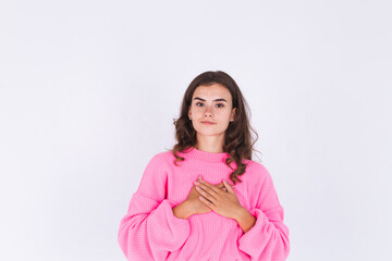 Young beautiful woman with freckles light makeup in sweater on white background loving herself,...