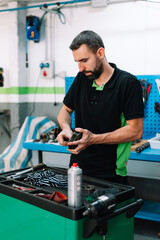 Mechanic checking car parts in the work shop