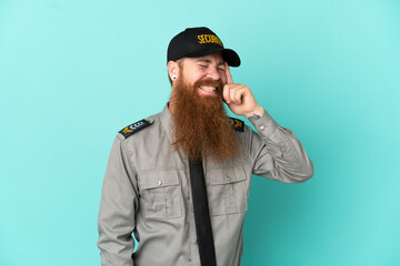 Redhead security man isolated on white background laughing