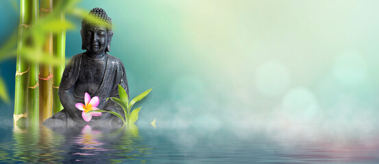 wellness background with buddha, bamboo and frangipani flowers