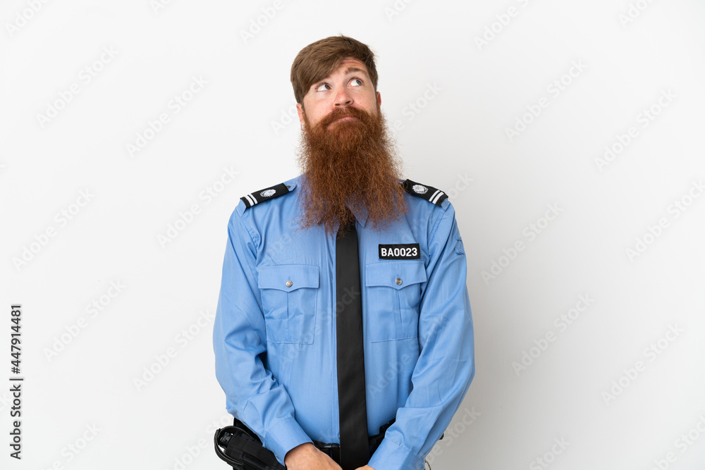 Wall mural Redhead police man isolated on white background and looking up