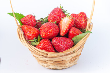 A basket of strawberries. The summer dessert is isolated on a white background. Healthy eating
