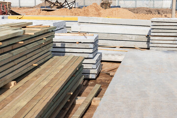 Storage of boards and building materials at the construction site. Preparation of material for building a house.