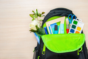 The Student backpack with different stationery on light background, flat lay with space for text. Back to school