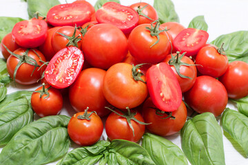 group of fresh red tomatoes and green leaf of fresh basil