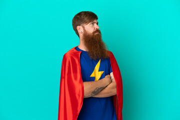 Redhead man in superhero costume with arms crossed