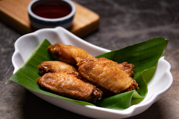 Fried chicken wings in a white cup. The view from the top. Space for text.