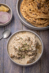 cream chicken curry with flatbread chapati or parantha