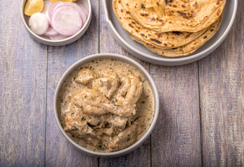 cream chicken curry with flatbread chapati or parantha