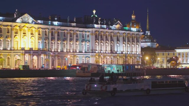 Saint-Petersburg, RUSSIA - May 29 2021, 4k: pleasure boats with tourists, view the Palace Bridge and Hermitage museum, on May 29, 2021 in Saint Petersburg, Russia