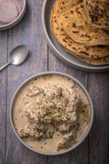 cream chicken curry with flatbread chapati or parantha