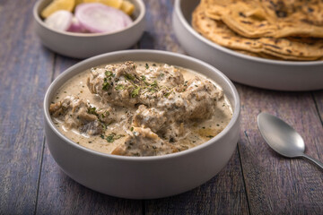 cream chicken curry with flatbread chapati or parantha