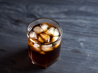 cold brew coffee with ice cubes on a black table close-up