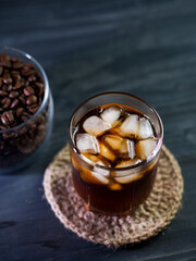 cold brew coffee with ice cubes on a black table close-up