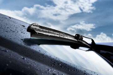 Closeup of wet windshield wiper, wipping windscreen outside - obrazy, fototapety, plakaty