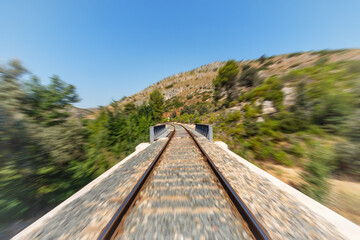 Train track crossing mountains with a speed visual effect.