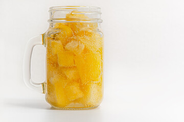 homemade yellow watermelon drink in a glass mason jar close up