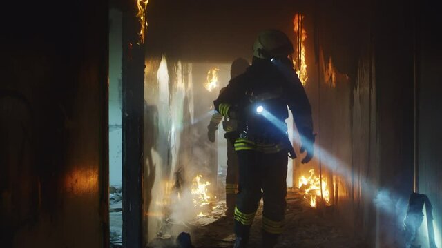 Firemen examining burning corridor during rescue operation
