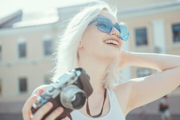 Young beauty woman blonde hair make photo on film camera, photographer