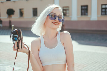 Young beauty woman blonde hair make photo on film camera, photographer