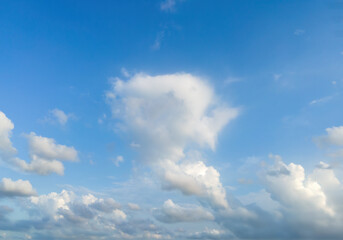Looking up at the blue sky and white clouds background