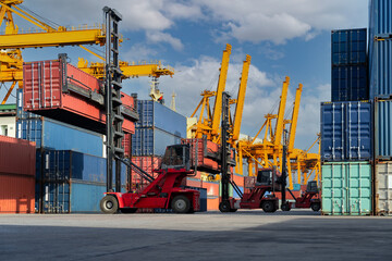 Engineers are overseeing the transportation of cargo with containers inside the warehouse....