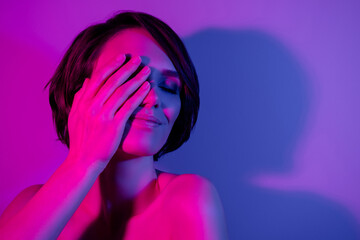 Photo portrait girl bob hairstyle covered eye with hand smiling isolated neon color background...