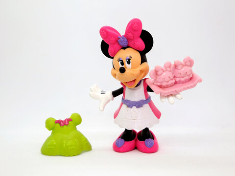 Minnie Mouse with dress to change clothes and a cake. Toy. Cartoon characters from Walt Disney Pictures Studios. Minnie is Mickey Mouse's girlfriend. Doll with interchangeable clothes. Isolated 