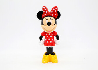 Minnie Mouse in a red and white polka dot dress with a bow to match