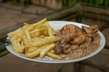 Poseidon steak  - a beef stake under souse with prawns 
